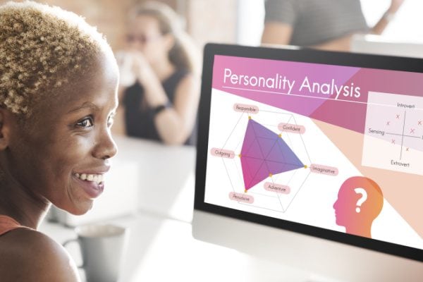 woman sitting at a computer screen with her personality analysis graphic