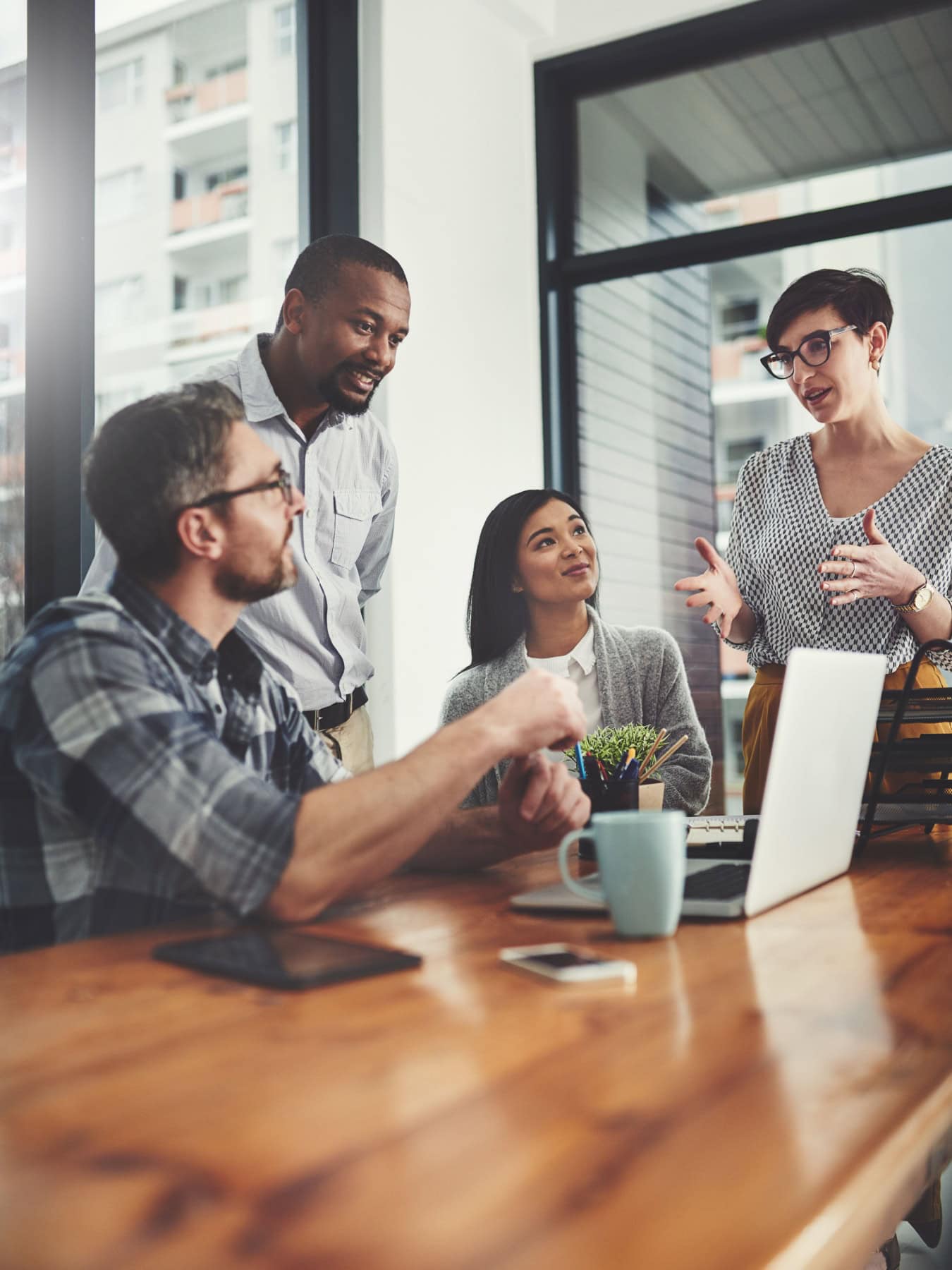 A group of professional coaches in an organization gather in an office setting