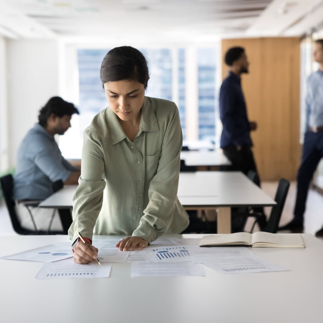 A woman is looking through the ethical resources in an office.