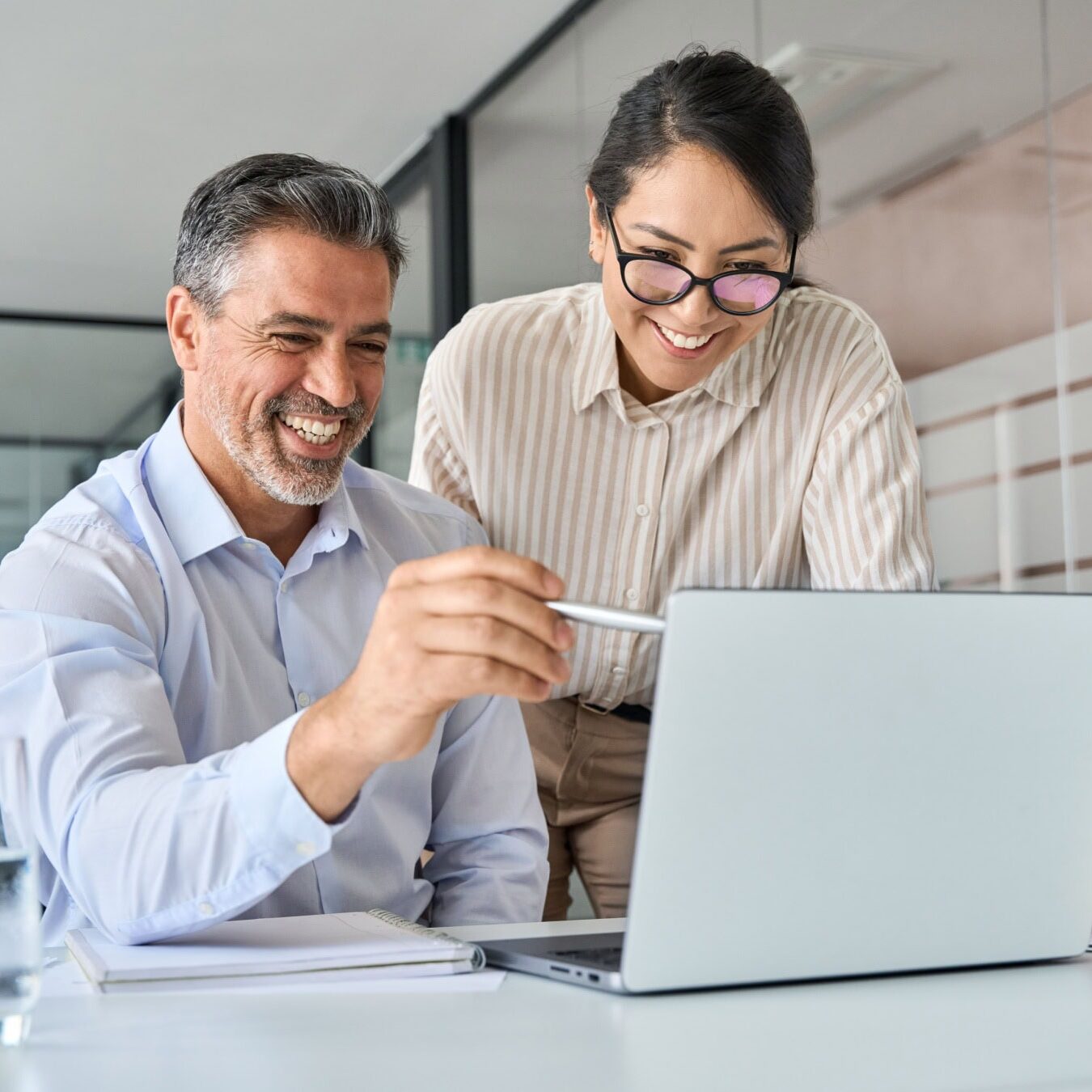 A man and a woman looks a laptop to see how best to prepare for the performance evaluations