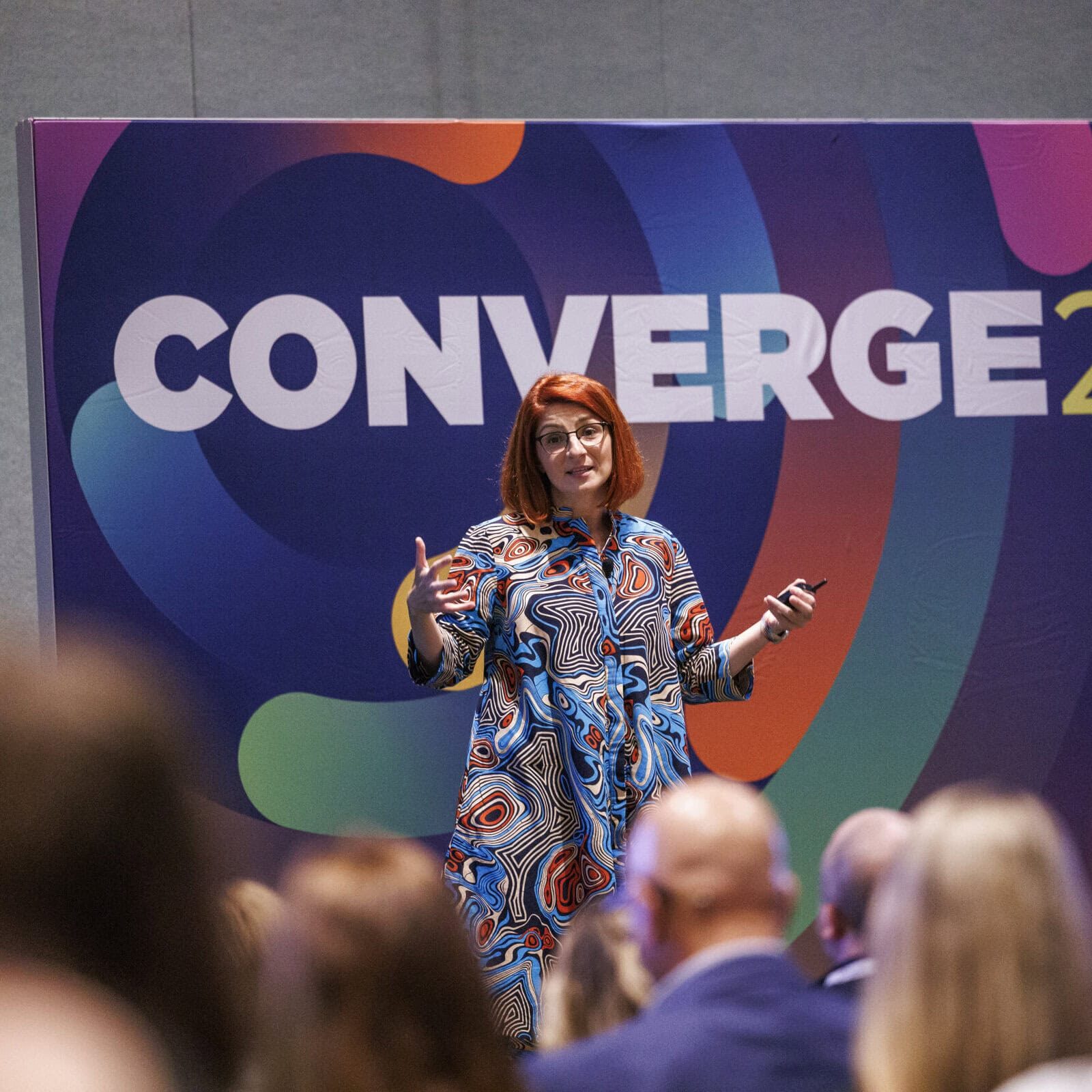 A professional speaker addressing an audience about leadership coaching at an International Coaching Federation event.