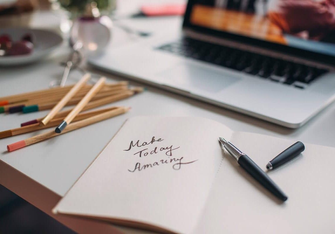 Notepad with make today amazing written on it, with a pen. Inspiration for achieving personal success