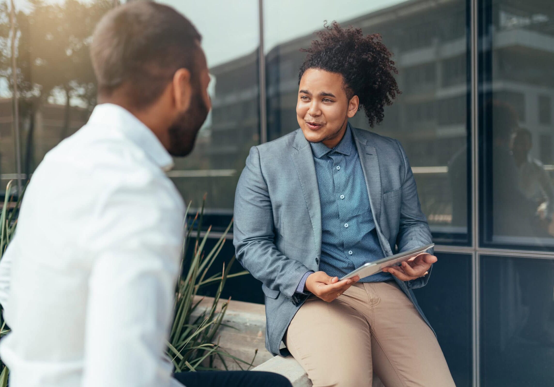 A researcher analyzing data on coaching effectiveness displayed on a laptop screen.