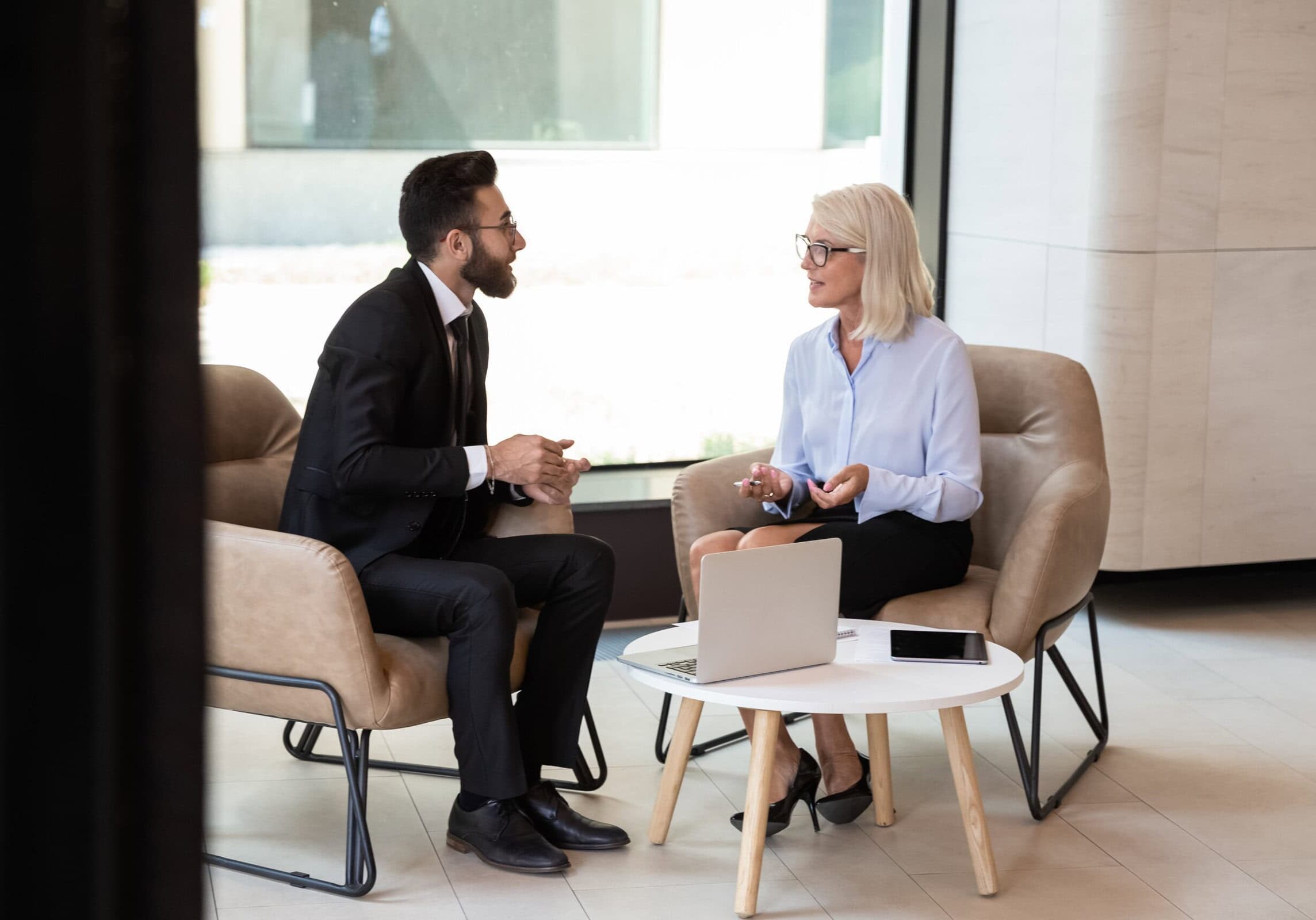 A variety of coaching tools, including worksheets and digital resources, displayed on a desk.