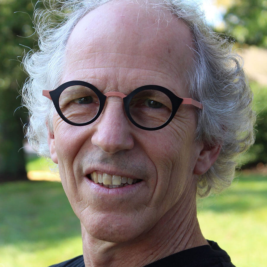 Joel DiGirolamo is the vice president of research and data science for ICF, headshot is of a man smiling with glasses on wearing a black shirt in nature.