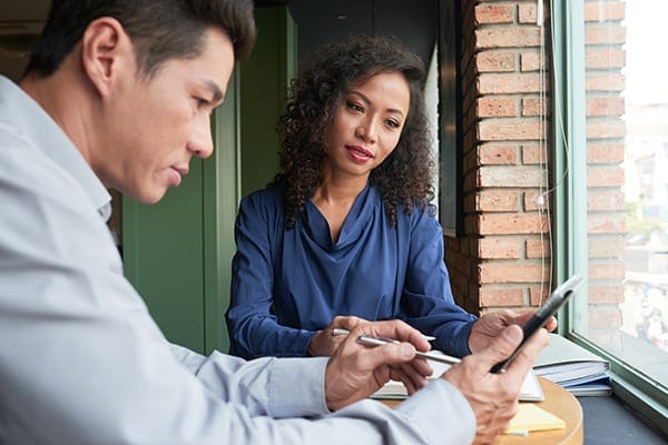 woman supervising man using a cellphone