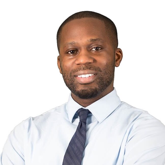 Tolu Akande MCC headshot photo, smiling man wearing light button up shirt and gray tie in front of white background